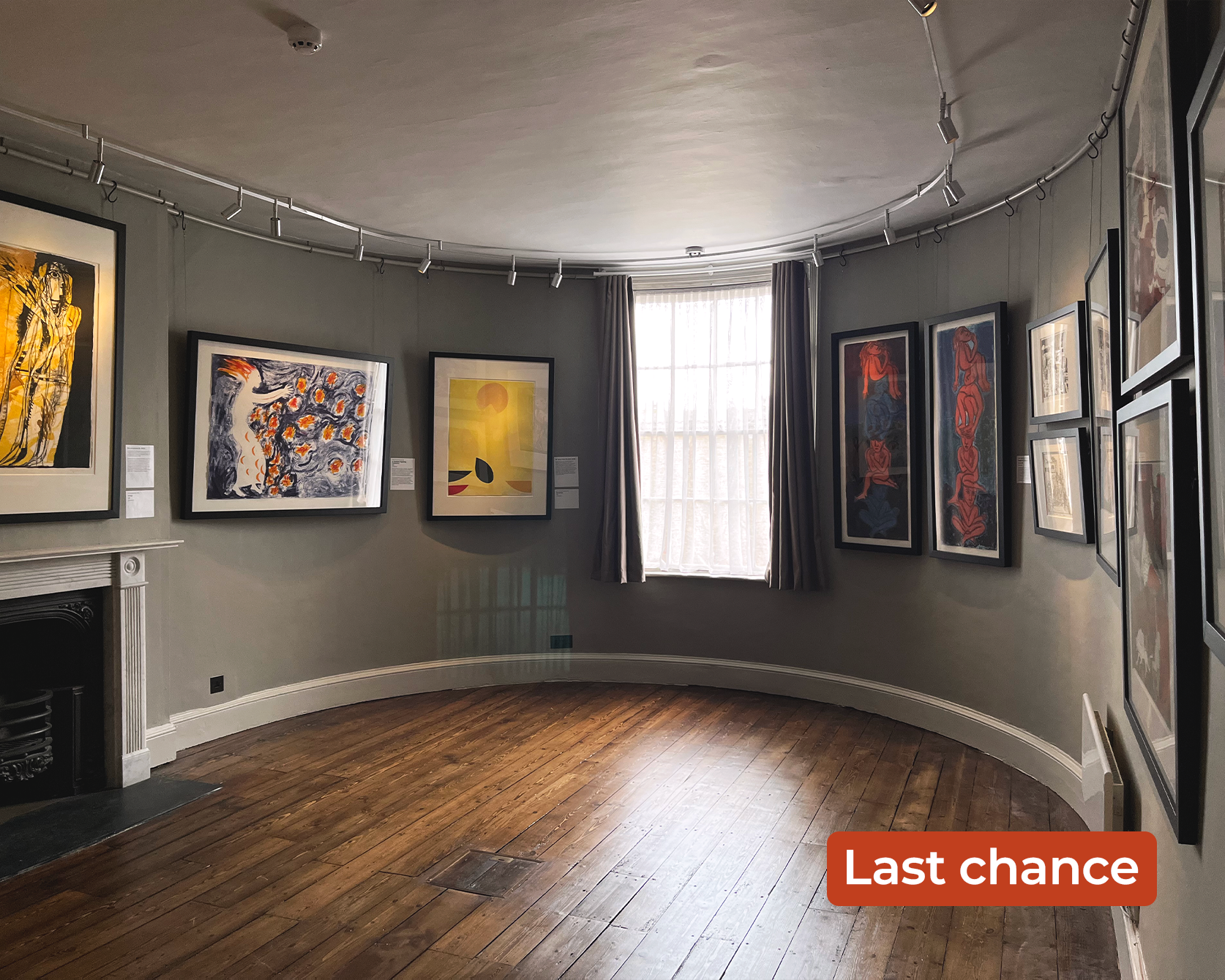 An image taken of the Striking Editions lithograph exhibition. There are numerous prints framed on the walls. The Upper Bow Room has a rounded back wall. The words 'Last chance' are overlayed in the bottom right corner.