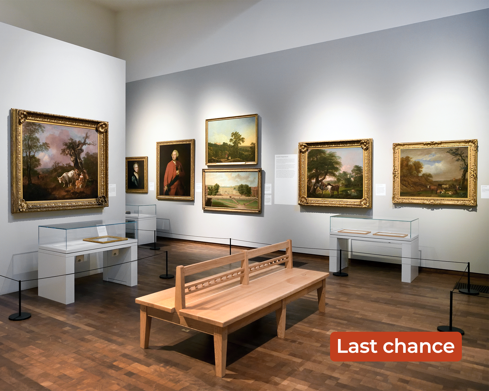 An image taken within the Timothy & Mary Clode Gallery of the Woburn exhibition.It shows a series of masterpieces on the wall and artefact cabinets, as well as a Suffolk style bench in the centre. The words 'Last chance' are overlayed in the bottom right corner.