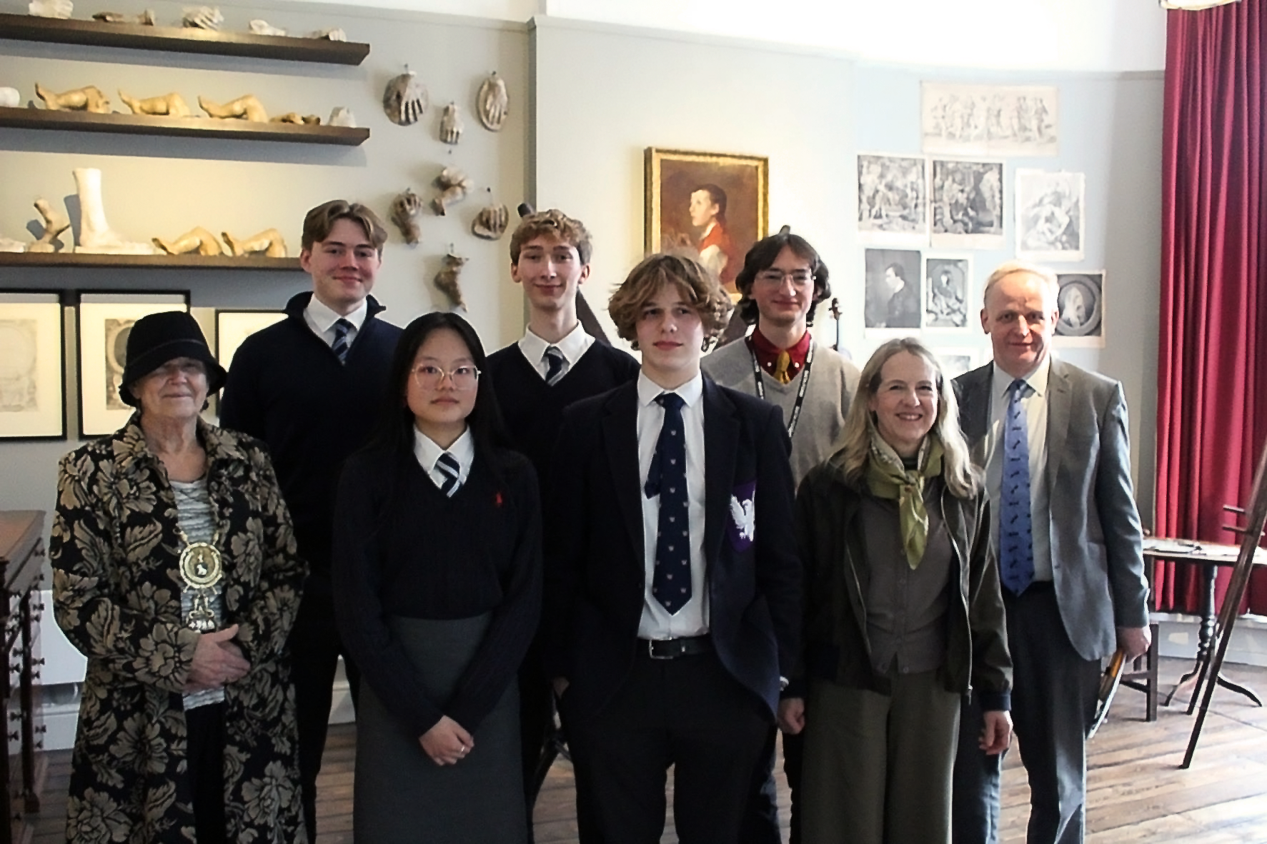 An image of all 5 student contestants. Pictured with the Mayor of Sudbury, Events Co-ordinator and Director of Gainsborough's House. They are all stood in the Finnis Scott Drawing Room.