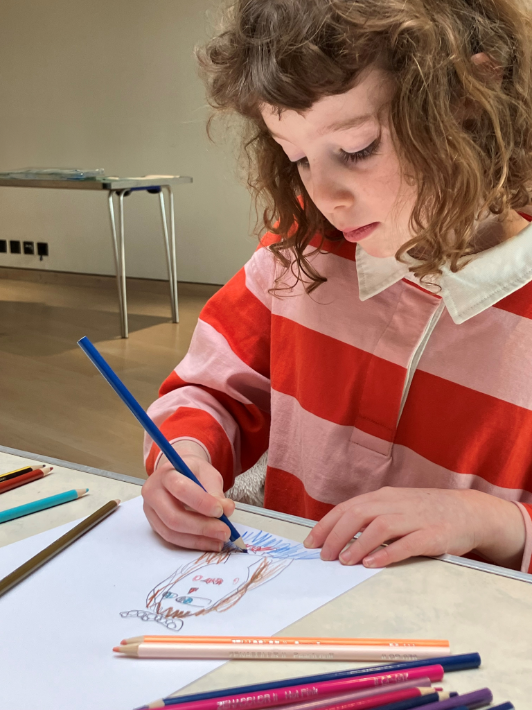 An image of a child drawing on paper in the Landscape Studio at Gainsborough's House.