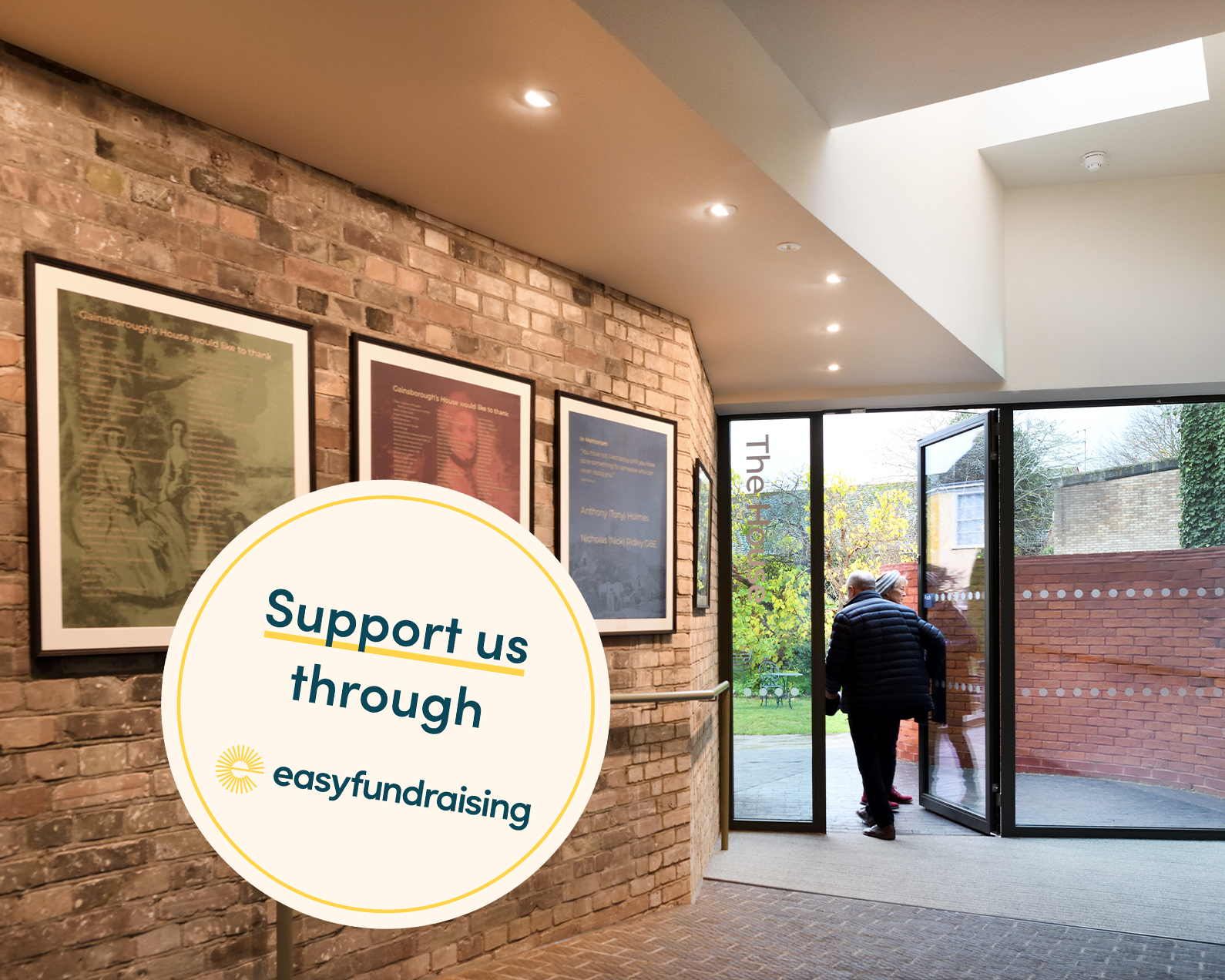 An image of the lobby area at Gainsborough's House. There are silk donor panels on the walls and two visitors exiting into the garden. There is an overlayed graphic which reads 'Support us through easyfundraising'.