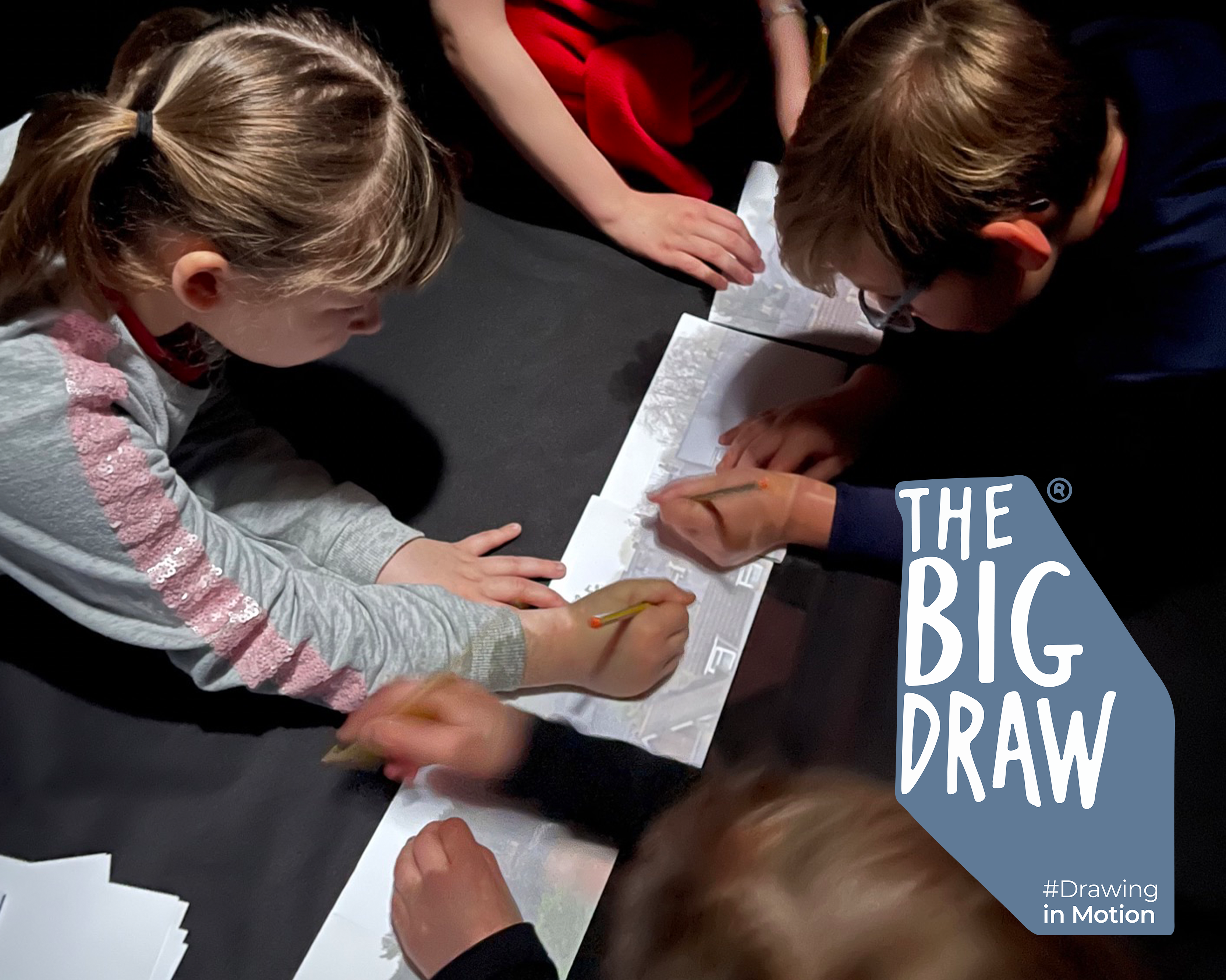 An image of children drawing with the Camera Obscura. The Big Draw logo is overlayed in the bottom right corner.