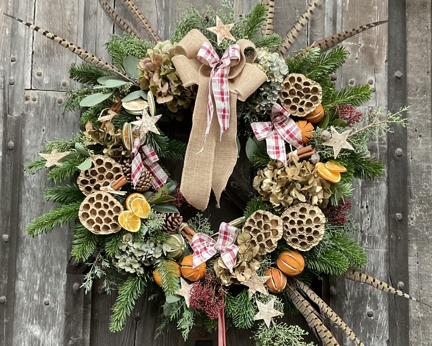 An image of a Christmas wreath on a wooden door.